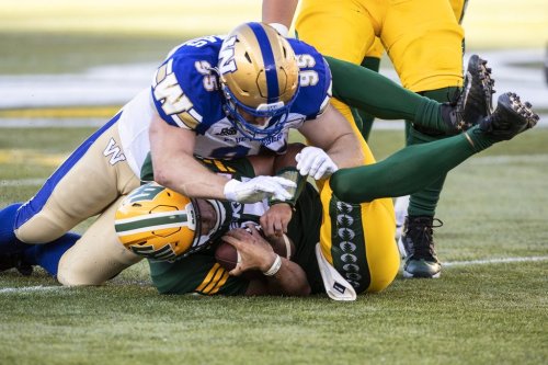 Winnipeg Blue Bombers Jake Thomas (95) sacks Edmonton Elks quarterback Taylor Cornelius (15) during first half CFL action in Edmonton, Alta., on Friday July 22, 2022. Thomas agreed to terms on a one-year extension with Winnipeg on Friday.THE CANADIAN PRESS/Jason Franson