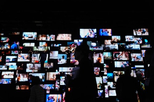 People walk past screens at the LG Electronics booth during the CES tech show Tuesday, Jan. 6, 2026, in Las Vegas. (AP Photo/Abbie Parr)