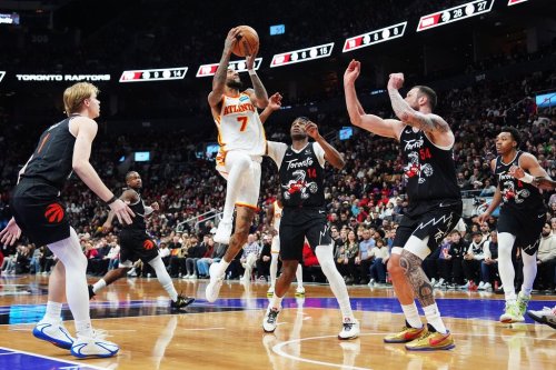Atlanta Hawks' Nickeil Alexander-Walker (7) shoots as Toronto Raptors' Gradey Dick (left), Ja'Kobe Walter (14) and Sandro Mamukelashvili (54) defend during second half NBA basketball action in Toronto on Saturday, Jan. 3, 2026. THE CANADIAN PRESS/Frank Gunn