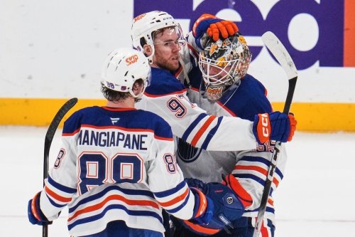 Edmonton Oilers goaltender Tristan Jarry, right, celebrates with Connor McDavid, centre, and Andrew Mangiapane (88) following an NHL hockey game against the Pittsburgh Penguins in Pittsburgh, Tuesday, Dec. 16, 2025. (AP Photo/Gene J. Puskar)