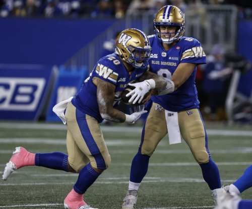 Winnipeg Blue Bombers quarterback Zach Collaros (8) hands off to Brady Oliveira (20) during first half CFL action against the Saskatchewan Roughriders in Winnipeg, Friday, Oct. 17, 2025. THE CANADIAN PRESS/John Woods