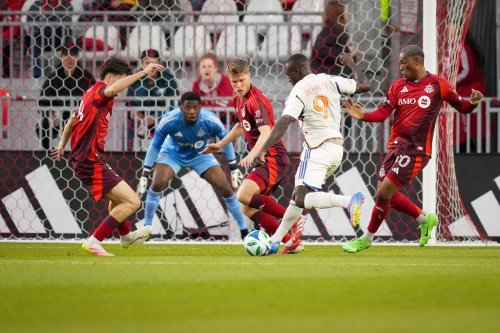 FC Cincinnati forward Kevin Denkey (9) shoots to score a goal against Toronto FC goalkeeper Sean Johnson (second left) during first half MLS soccer action in Toronto on Wednesday, May 14, 2025. THE CANADIAN PRESS/Arlyn McAdorey
