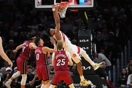 Toronto Raptors forward Scottie Barnes, right, dunks during the first half of an NBA basketball game against the Miami Heat, Tuesday, Dec. 23, 2025, in Miami. (AP Photo/Lynne Sladky)
