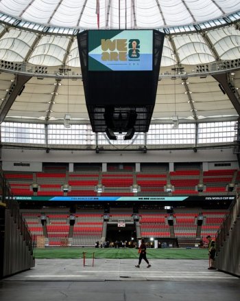 A worker walks across a tunnel at B.C. Place during a FIFA World Cup 2026 update in Vancouver, Tuesday, April 30, 2024. THE CANADIAN PRESS/Ethan Cairns