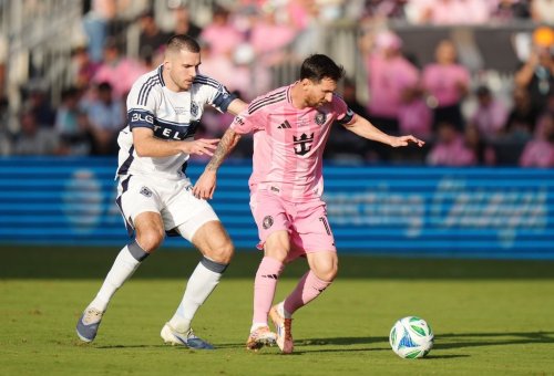 Inter Miami's Lionel Messi (right) protects the ball from Vancouver Whitecaps' Joedrick Pupe (23) during the second half of the MLS Cup final soccer match, in Fort Lauderdale, Fla., on Saturday, December 6, 2025. THE CANADIAN PRESS/Darryl Dyck