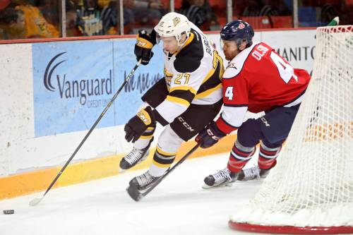 Brandon Wheat Kings forward Luka Burzan (27) plays the puck with Lethbridge Hurricanes defenceman Tate Olson (4) right behind him during Game 4 of the Eastern Conference semifinals on March 11, 2018. Burzan was acquired from the Moose Jaw Warriors at the 2018 deadline in one of the biggest trades in team history. (Tim Smith/The Brandon Sun)