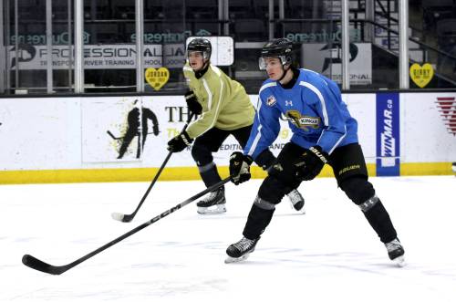 Brandon Wheat Kings forward Nick Johnson, in the olive jersey, and Carter Klippenstein, in blue, participate in a two-on-two drill during practice at Assiniboine Credit Union Place on Friday as the team prepared for a matchup against the Regina Pats this evening at 6 p.m. The pair are happy they&rsquo;ll finish the season as Wheat Kings. (Perry Bergson/The Brandon Sun)
                                Jan. 10, 2026