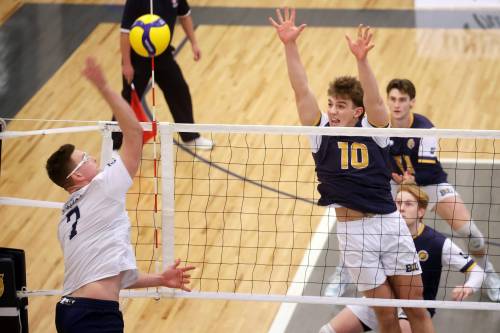 Matthew Siebenga (10) of the Brandon Bobcats leaps to block an attack by Kaden Schmidt (7) of the Trinity Western Spartans during university men&rsquo;s volleyball action at the Health Living Centre on Friday. (Tim Smith/The Brandon Sun)