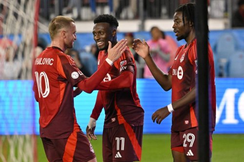 Toronto FC's Djordje Mihailovic, left, celebrates scoring against Orlando City SC with Derrick Etienne Jr, middle, and Deandre Kerr, right, during second half MLS soccer action in Toronto on Saturday, Oct. 18, 2025. THE CANADIAN PRESS/Jon Blacker