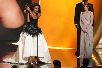 Olivia Dean accepts the award for best new artis during the 68th annual Grammy Awards on Sunday, Feb. 1, 2026, in Los Angeles. Chappell Roan looks on from right. (AP Photo/Chris Pizzello)