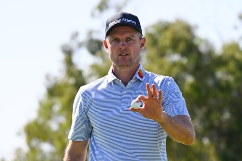 Justin Rose, of England, acknowledges the gallery after making a putt on the sixth green of the South Course at Torrey Pines during the third round of the Farmers Insurance Open golf tournament Saturday, Jan. 31, 2026, in San Diego. (AP Photo/Denis Poroy)