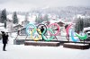 FILE - People take photos in front of the Milan Cortina Winter Olympics and Paralympics rings, in Cortina D'Ampezzo, Thursday, Nov. 20, 2025. (AP Photo/Andrew Medichini, File)