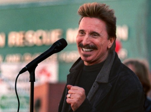 FILE - Chuck Negron, former lead singer of Three Dog Night, sings to a crowd during a Christmas Eve party, Dec. 24, 1997, at the Union Rescue Mission in Los Angeles. (AP Photo/John Hayes, File)