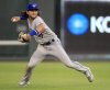 Toronto Blue Jays shortstop Bo Bichette fields a ball in left field hit by Kansas City Royals' Cheslor Cuthbert during the fourth inning of a baseball game at Kauffman Stadium in Kansas City, Mo., Monday, July 29, 2019. Cuthbert doubled on the play. (AP Photo/Orlin Wagner)