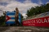 Felix Jose Morfi stands by his solar-powered water heater system he set up on his home's roof in Regla, Havana province, Cuba, Thursday. Jan. 29, 2026. (AP Photo/Ramon Espinosa)
