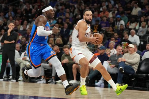 Phoenix Suns forward Dillon Brooks drives past Oklahoma City Thunder guard Luguentz Dort (5) during the second half of an NBA basketball game, Wednesday, Feb. 11, 2026, in Phoenix. (AP Photo/Rick Scuteri)