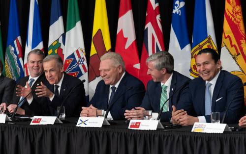 P.E.I. Premier Bloyce Thompson (from left), Ontario Premier Doug Ford, Nova Scotia Premier Tim Houston and Manitoba Premier Wab Kinew react as Prime Minister Mark Carney speaks at the end of a news conference following the First Ministers Meeting in Ottawa on Thursday. The federal government is poised to hand more of the responsibility for major project assessments to provinces, but Manitoba isn&rsquo;t ready. (The Canadian Press)