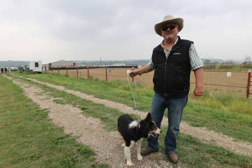 Campbell Forsyth stands with his dog Mac at the Minnedosa Agricultral Grounds. The two competed at the 2024 Show and Sale, going for the fastest time and highest accuracy herding sheep through barrels and into a pen. (Connor McDowell/Brandon Sun)
