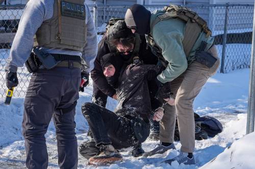 A person is detained by U.S. federal agents in Minneapolis on Tuesday. (The Associated Press)