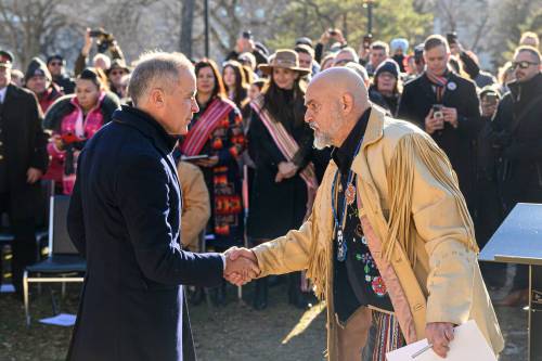 Prime Minister Mark Carney shakes hands with Manitoba Métis Federation Housing Minister Will Goodon during an event last November marking the 145th anniversary of Louis Riel&rsquo;s execution at the St. Boniface Cathedral cemetery in Winnipeg. (Mike Sudoma/Winnipeg Free Press files)