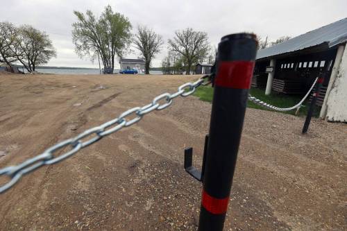 Chained gates stand in Ninette outside the boat launch onto Pelican Lake in 2025. The gates were installed at all launches around the lake by the Rural Municipality of Prairie Lakes as part of a plan to regulate access to the lake. The plan is set to continue in 2026 as the municipality wants to be proactive in keeping aquatic invasive species out. (Connor McDowell/Brandon Sun files)