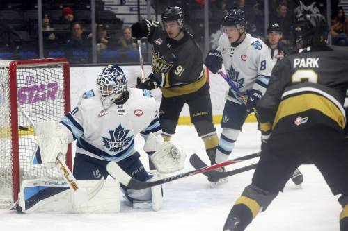 Ryan Boyce (91) and Carson Park (3) of Brandon watch as goalie Ethan McCallum (30) of the Penticton Vees deflects a shot on net during WHL action at Assiniboine Credit Union Place on Friday evening. (Tim Smith/The Brandon Sun)