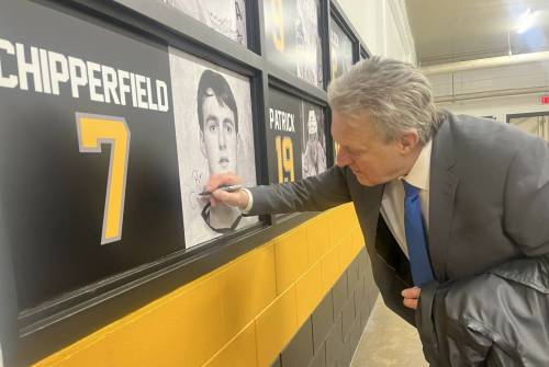 Former Brandon Wheat Kings forward Ron Chipperfield signs his picture on the team&rsquo;s Wall of Honour prior to the team&rsquo;s game against the Penticton Vees on Friday. Chipperfield was inducted into the Brandon Wheat Kings Hall of Fame on Thursday. (Perry Bergson/The Brandon Sun)