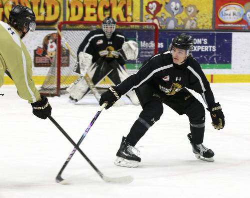 Defenceman Nigel Boehm (12) defends against forward Brady Turko (7) in front of practice goalie Sawyer Wallin as the Brandon Wheat Kings prepare for the Regina Pats during practice at Assiniboine Credit Union Place on Thursday. (Perry Bergson/The Brandon Sun) Feb. 26, 2026