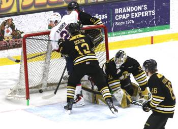 Regina Pats forward Ruslan Karimov (25) appears to score on Brandon Wheat Kings goalie Filip Ruzicka (30) as Nigel Boehm (12), Cameron Allard (6) and Luke Mistelbacher (26) look on during Western Hockey League action at Assiniboine Credit Union Place on Friday. It was quickly ruled to be no goal &mdash; no doubt because the forward beat the puck into the crease &mdash; and didn&rsquo;t go to a video review. (Perry Bergson/The Brandon Sun)