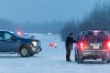 A Saskatchewan Conservation Officer conducts a road blockade at Big Island Lake Cree Nation, 392 kilometres northwest of Saskatoon, on Tuesday Dec. 30, 2025. THE CANADIAN PRESS/Timothy Matwey