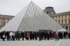 People queue outside the Louvre museum, in Paris, France, Friday, Feb. 13, 2026. (AP Photo/Michel Euler)