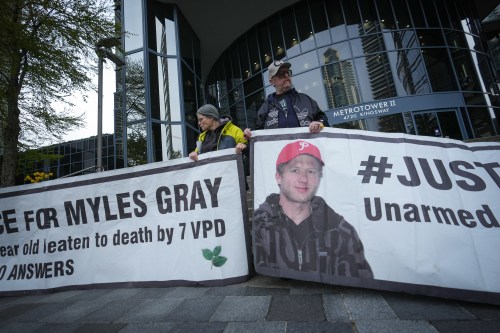 Protesters hold banners with a photograph of Myles Gray, who died following a confrontation with several police officers in 2015, before the start of a coroner's inquest into his death, in Burnaby, B.C., on Monday, April 17, 2023. THE CANADIAN PRESS/Darryl Dyck