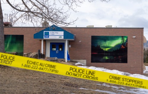 Police tape surrounds a school in Tumbler Ridge, B.C., on Thursday, Feb. 12, 2026. THE CANADIAN PRESS/Christinne Muschi