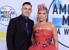 FILE - Singer Pink, right, and Carey Hart appear at the American Music Awards in Los Angeles on Nov. 19, 2017. (Photo by Jordan Strauss/Invision/AP, File)