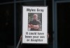 A person holds a sign with a photo of Myles Gray, who died following a confrontation with several police officers in 2015, before the start of a coroner's inquest into his death, in Burnaby, B.C., on April 17, 2023. THE CANADIAN PRESS/Darryl Dyck