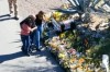 This image made from video provided by FOX News Digital shows Savannah Guthrie, right, her sister Annie Guthrie, left, and her brother-in-law Tommaso Cioni, Monday, March 2, 2026, visiting a tribute to their mother Nancy Guthrie. (FOX News Digital via AP)