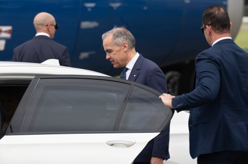 Prime Minister Mark Carney gets into a waiting vehicle as he arrives in Sydney, Australia, Tuesday, March 3, 2026. THE CANADIAN PRESS/Adrian Wyld