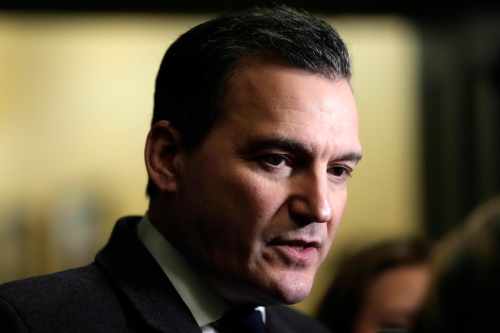 Minister of Artificial Intelligence and Digital Innovation Evan Solomon takes questions from journalists as he makes his way to a meeting of the Liberal caucus on Parliament Hill in Ottawa, on Wednesday, Feb. 25, 2026. THE CANADIAN PRESS/Justin Tang