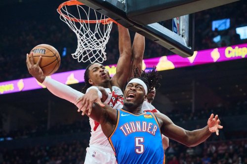 Oklahoma City Thunder's Luguentz Dort (5) is stopped at the net by Toronto Raptors' Collin Murray-Boyles (12) during first half NBA basketball action in Toronto, on Tuesday, Feb. 24, 2026. THE CANADIAN PRESS/Sammy Kogan