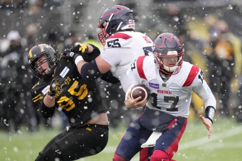 Montreal Alouettes quarterback Trevor Harris (17) scrambles as offensive lineman Landon Rice (55) blocks Hamilton Tiger-Cats defensive end Julian Howsare (95) during first half CFL division semi-final football action in Hamilton, Ont., on Sunday, November 28, 2021. THE CANADIAN PRESS/Nathan Denette