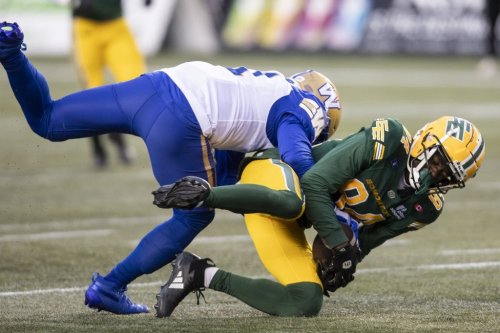 Winnipeg Blue Bombers' Jamal Parker (left) tackles Edmonton Elks' Odieu Hiliare (84) during first half CFL action in Edmonton on Saturday, October 11, 2025. THE CANADIAN PRESS/Amber Bracken
