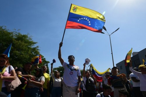People attend a student-led march on National Youth Day to call for the release of detainees, considered to be political prisoners by their relatives and human rights groups, in Valencia, Venezuela, Thursday, Feb. 12, 2026. (AP Photo/Jacinto Oliveros)
