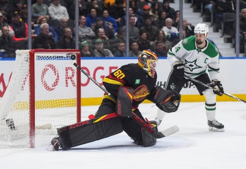 Vancouver Canucks goalie Nikita Tolopilo (60) allows a goal to Dallas Stars' Lian Bichsel, not seen, as Jamie Benn (14) watches during the second period of an NHL hockey game, in Vancouver, on Monday, March 2, 2026. THE CANADIAN PRESS/Darryl Dyck