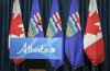 Alberta and Canadian flags are seen behind the podium in a media room in Calgary, on Friday, Oct. 17, 2025. THE CANADIAN PRESS/Jeff McIntosh