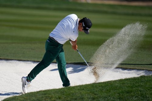 Ryo Hisatsune, of Japan, slams his club into the sand of a fairway bunker at the 10th hole after hitting a shot during the final round of the Phoenix Open golf tournament Sunday, Feb. 8, 2026, in Scottsdale, Ariz. (AP Photo/Ross D. Franklin)