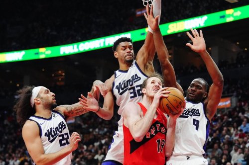 Raptors centre Jakob Poeltl (19) protects the ball from Devin Carter (22), Dylan Cardwell (32) and Precious Achiuwa (9) of the Sacramento Kings during an NBA game in Toronto on  April 1, 2026. THE CANADIAN PRESS/Frank Gunn