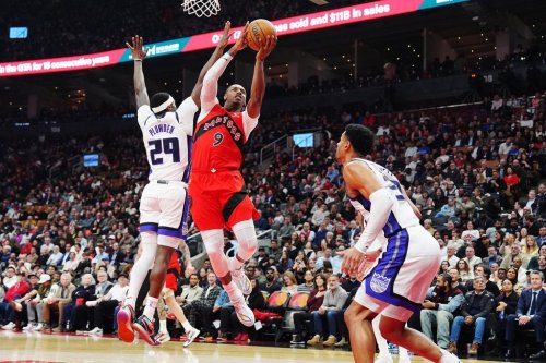 Toronto Raptors' RJ Barrett (9) leaps past Sacramento Kings' Daeqwon Plowden (29) as Dylan Cardwell (32) defends during first half NBA basketball action in Toronto on Wednesday, April 1, 2026. THE CANADIAN PRESS/Frank Gunn