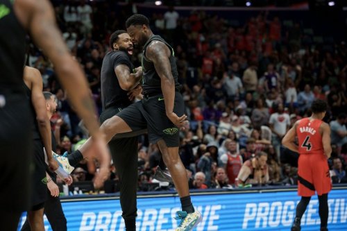 New Orleans Pelicans forward Zion Williamson, centre, celebrates a windmill dunk against the Toronto Raptors with centre DeAndre Jordan next to Toronto Raptors forward Scottie Barnes (4) during the second half of an NBA basketball game in New Orleans, Wednesday, March 11, 2026. (AP Photo/Matthew Hinton)