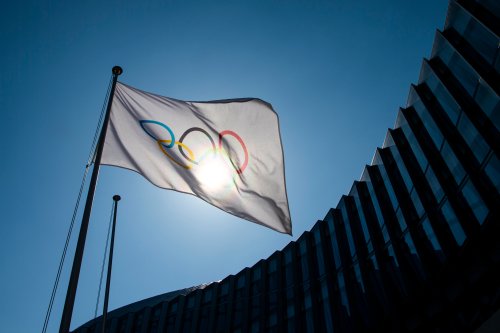 The Olympic flag is pictured outside the entrance of the International Olympic Committee headquarters in Lausanne, Switzerland, in this 2020 photo. The IOC has announced it’s introducing a new policy that will ban transgender athletes from competing in women’s events. (The Associated Press files)