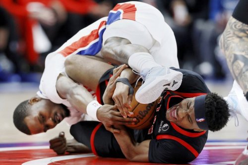 Toronto Raptors guard Ja'Kobe Walter, right, and Detroit Pistons guard Javonte Green fight over a loose ball during the first half of an NBA basketball game Tuesday, March 31, 2026, in Detroit. (AP Photo/Duane Burleson)